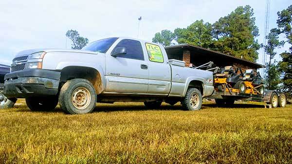 Truck towing lawn equipment