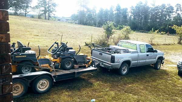 Lawn service truck pulling zero turn mowers